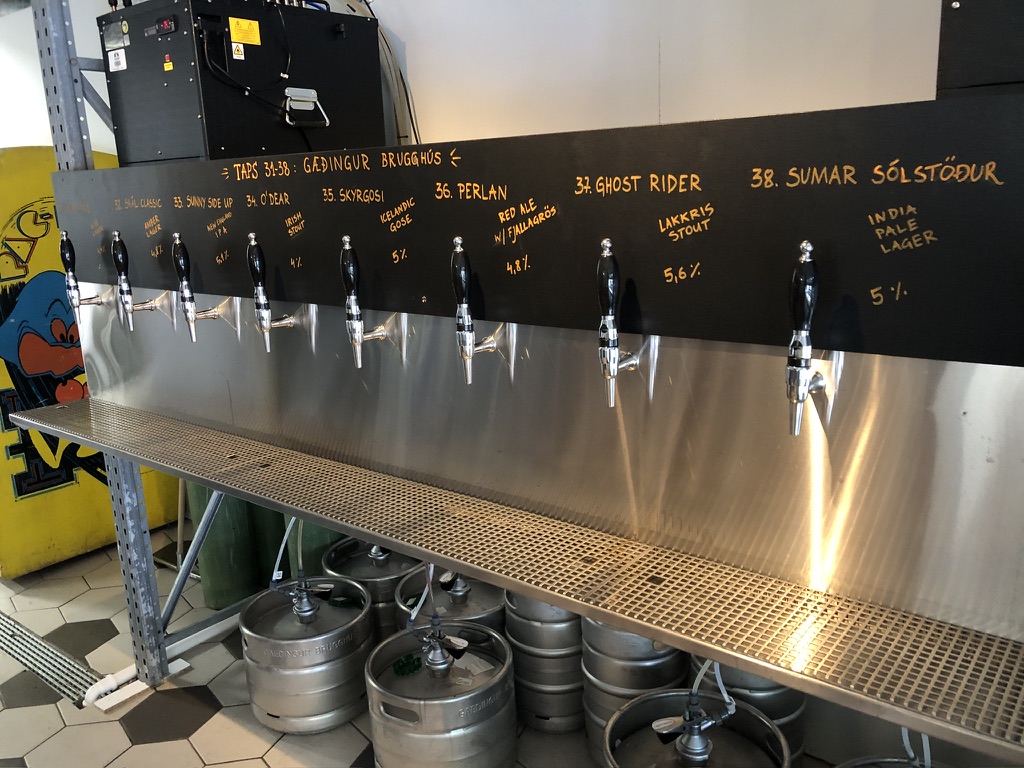 Draft tap wall studied during an Iceland brewery visit