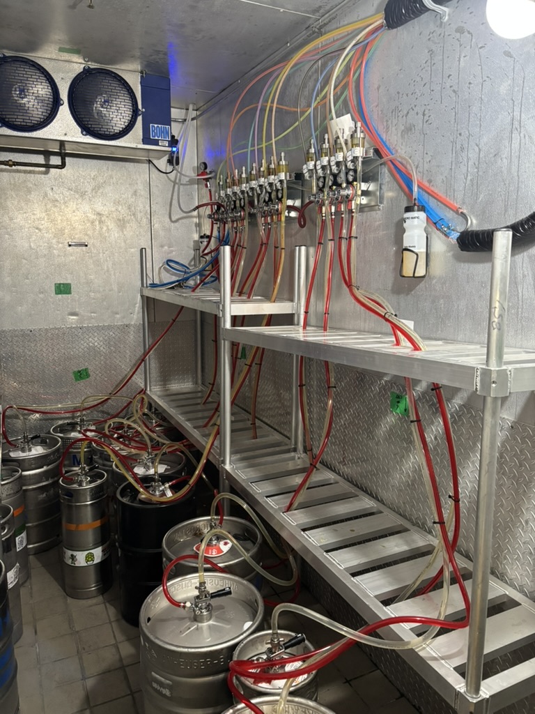Commercial walk-in cooler with organized racks and regulators